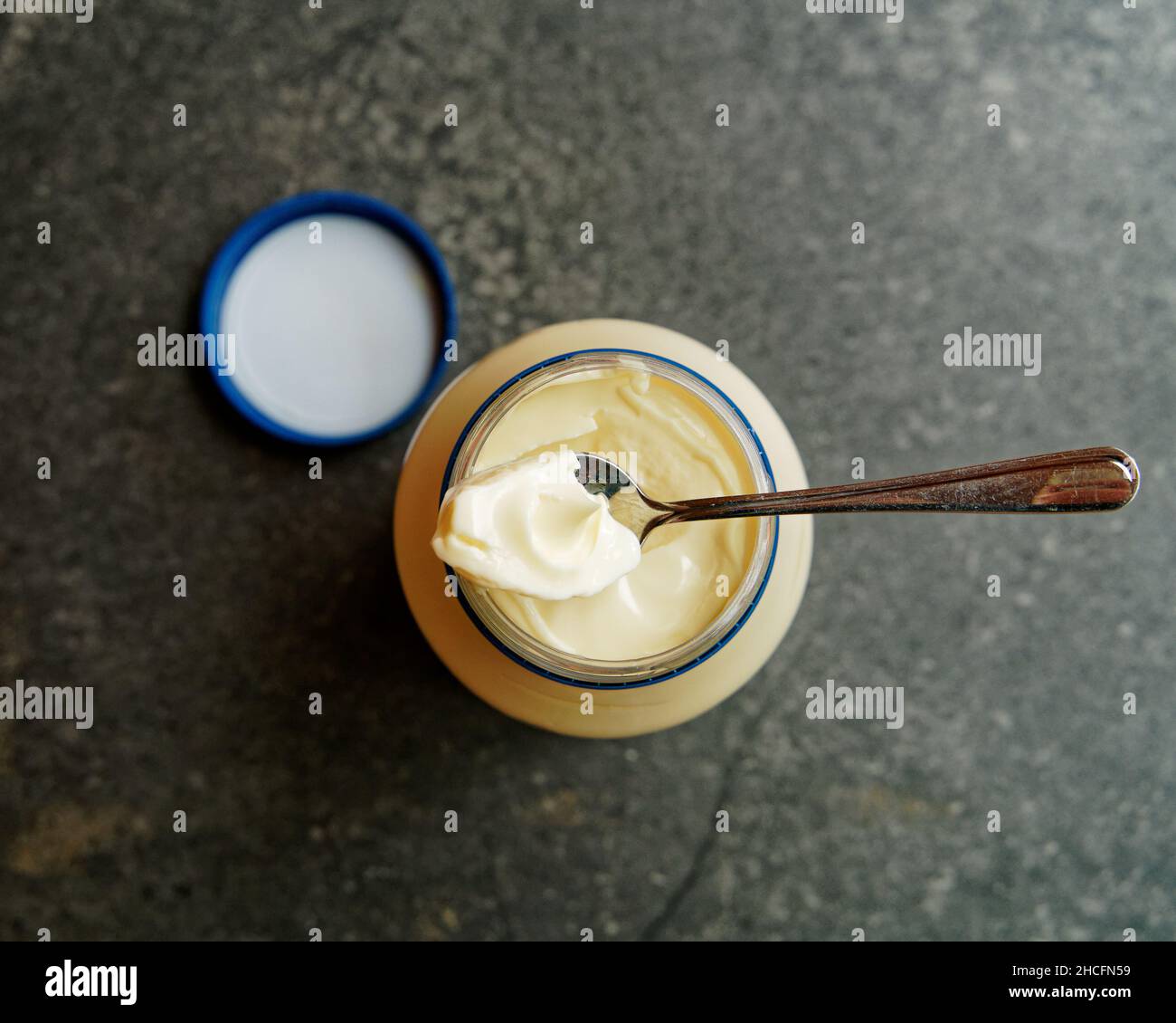 The best bit, the nipple on the top of the mayonnaise in a newly opened jar being spooned out to taste. Stock Photo