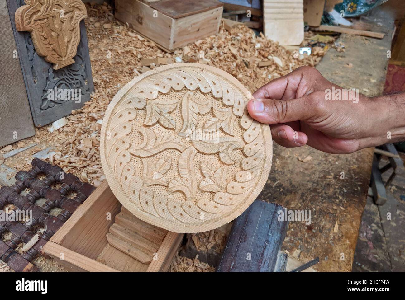 Wood crafts in the hand of a craftsman man in a wood workshop. Stock Photo