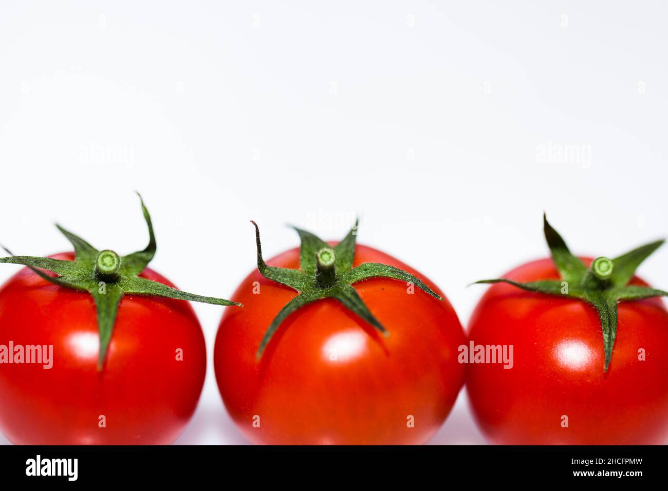 Ripe red tomatoes isolated on a white background Stock Photo - Alamy