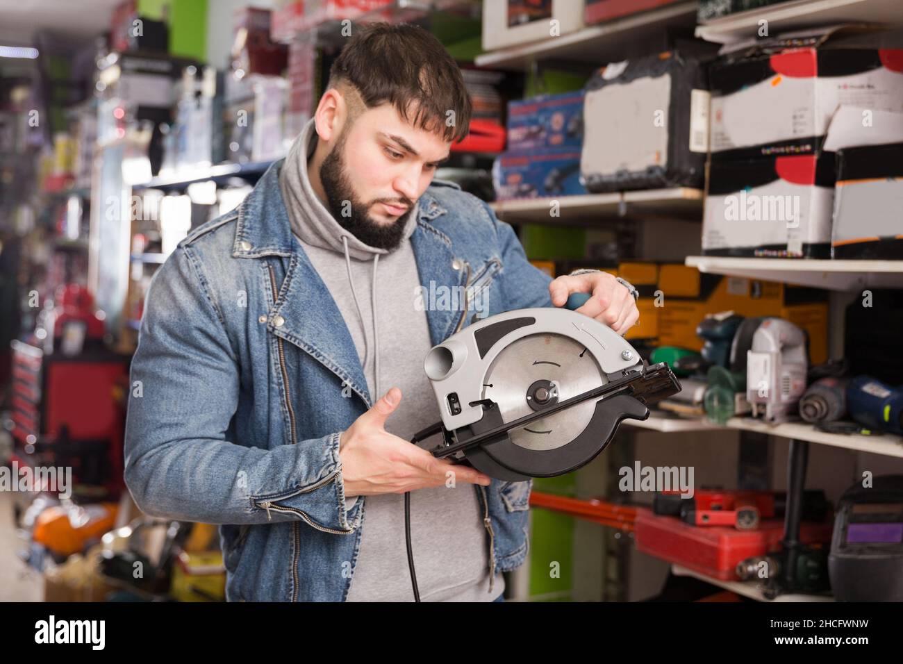 male engineer chooses circular saw in tool store Stock Photo Alamy