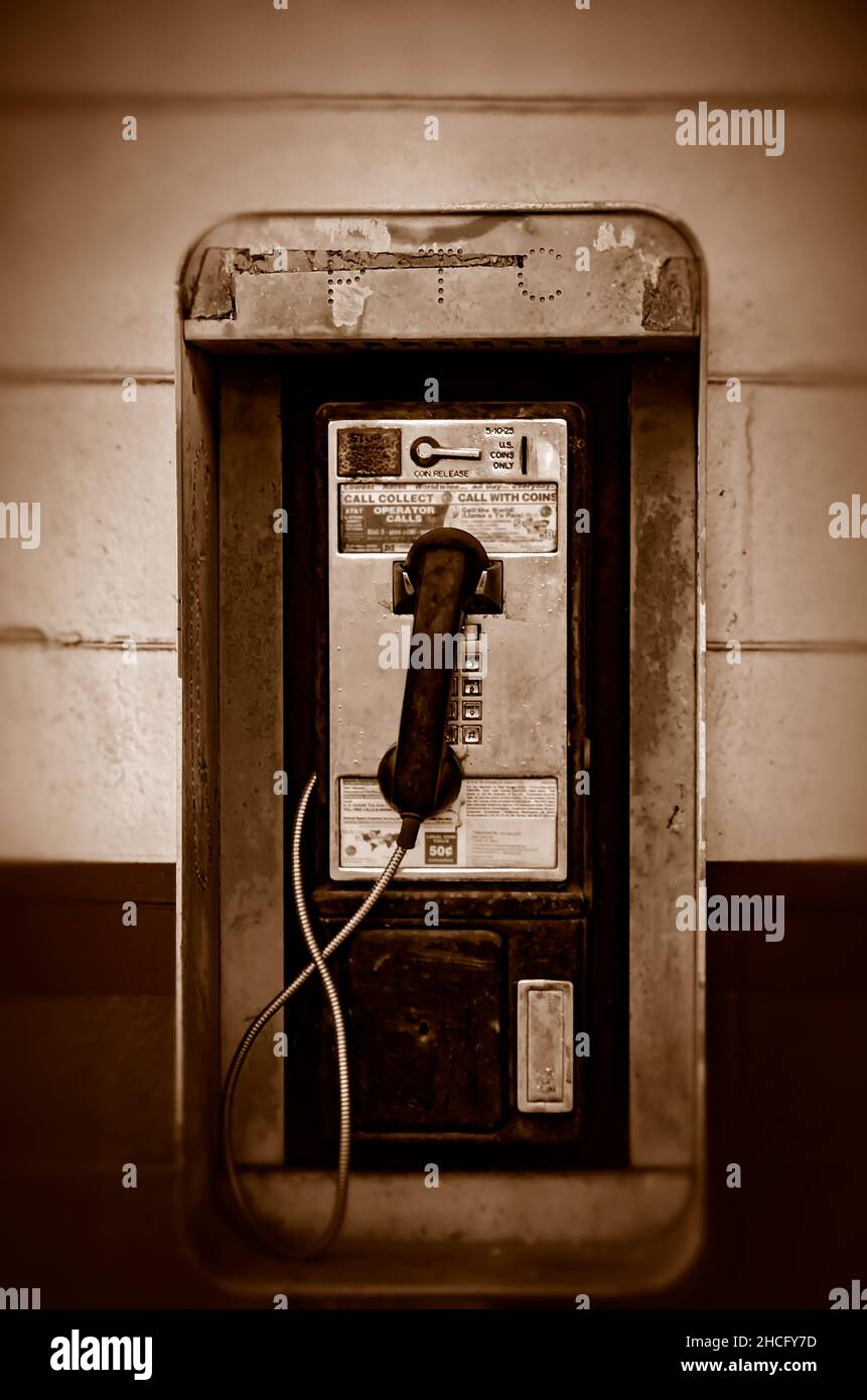 A coinoperated public telephone also called a payphone, hangs on the