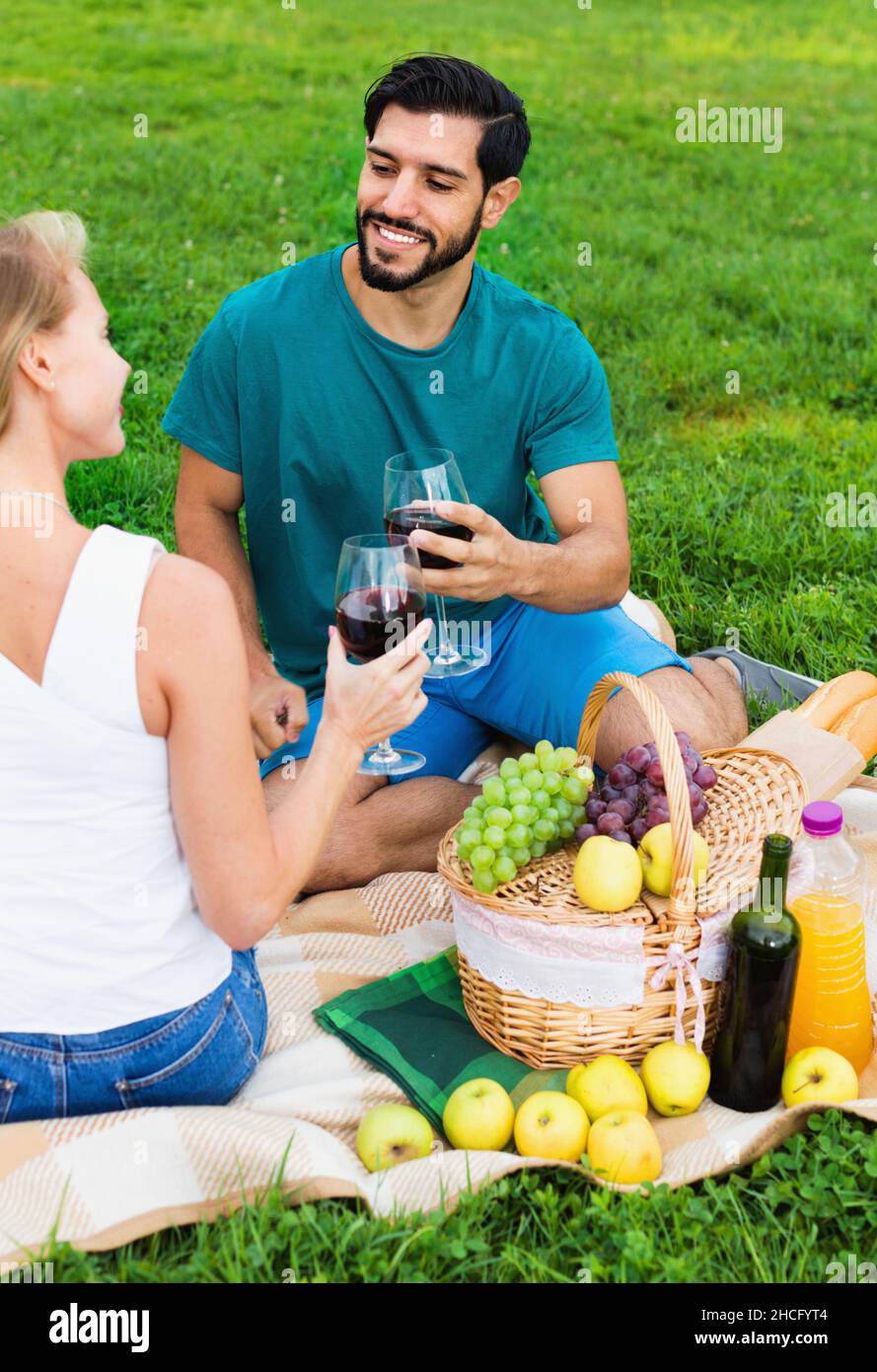 Couple are talking and drinking wine in time picnic outdoor Stock Photo ...