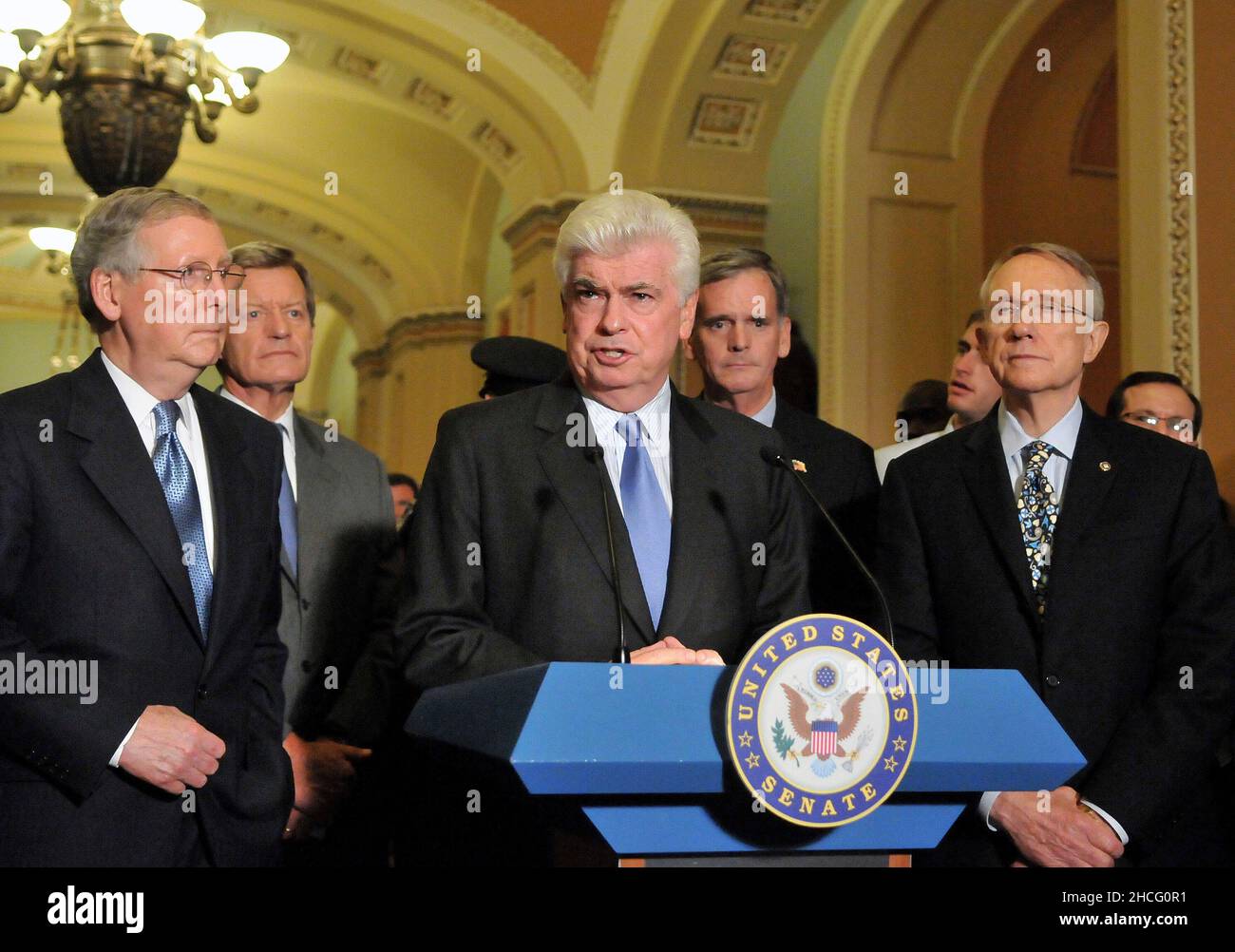Washington, DC - October 1, 2008 -- United States Senator Chris Dodd (Democrat of Connecticut) makes a statement to reporters outside the United States Senate Chamber in the United States Capitol after casting votes to pass the 700 billion dollar Wall Street bail-out package in Washington, DC on Wednesday, October 1, 2008. From left to right: United States Senator Mitch McConnell (Republican of Kentucky), the Minority Leader; United States Senator Max Baucus (Democrat of Montana); Senator Dodd; United States Senator Judd Gregg (Republican of New Hampshire; and United States Senator Harry Rei Stock Photo