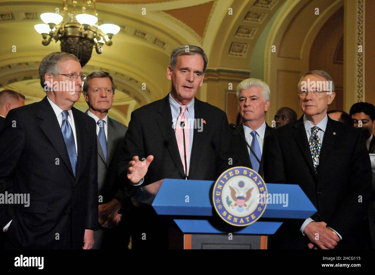 Washington, DC - October 1, 2008 -- United States Senator Judd Gregg (Republican of New Hampshire) makes a statement to reporters outside the United States Senate Chamber in the United States Capitol after casting votes to pass the 700 billion dollar Wall Street bail-out package in Washington, DC on Wednesday, October 1, 2008. From left to right: United States Senator Mitch McConnell (Republican of Kentucky), the Minority Leader; United States Senator Max Baucus (Democrat of Montana); Senator Gregg; United States Senator Chris Dodd (Democrat of Connecticut); and United States Senator Harry R Stock Photo