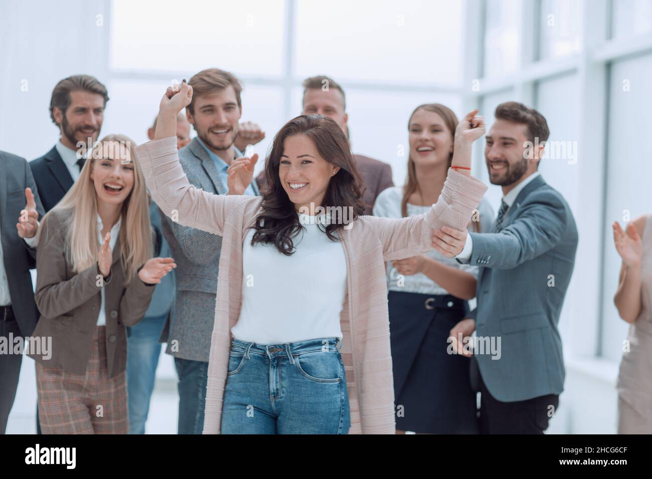 happy businesswoman standing in front of her team Stock Photo - Alamy