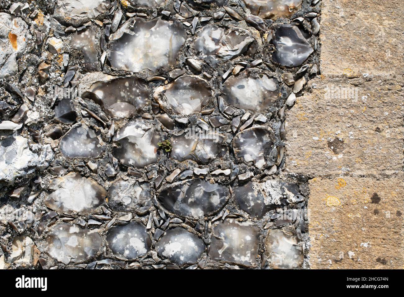 Knapped flint stone wall. Construction. Smaller knapped pieces impressed between single knapped larger ones. North Repps Parish Church, Near Cromer, N Stock Photo