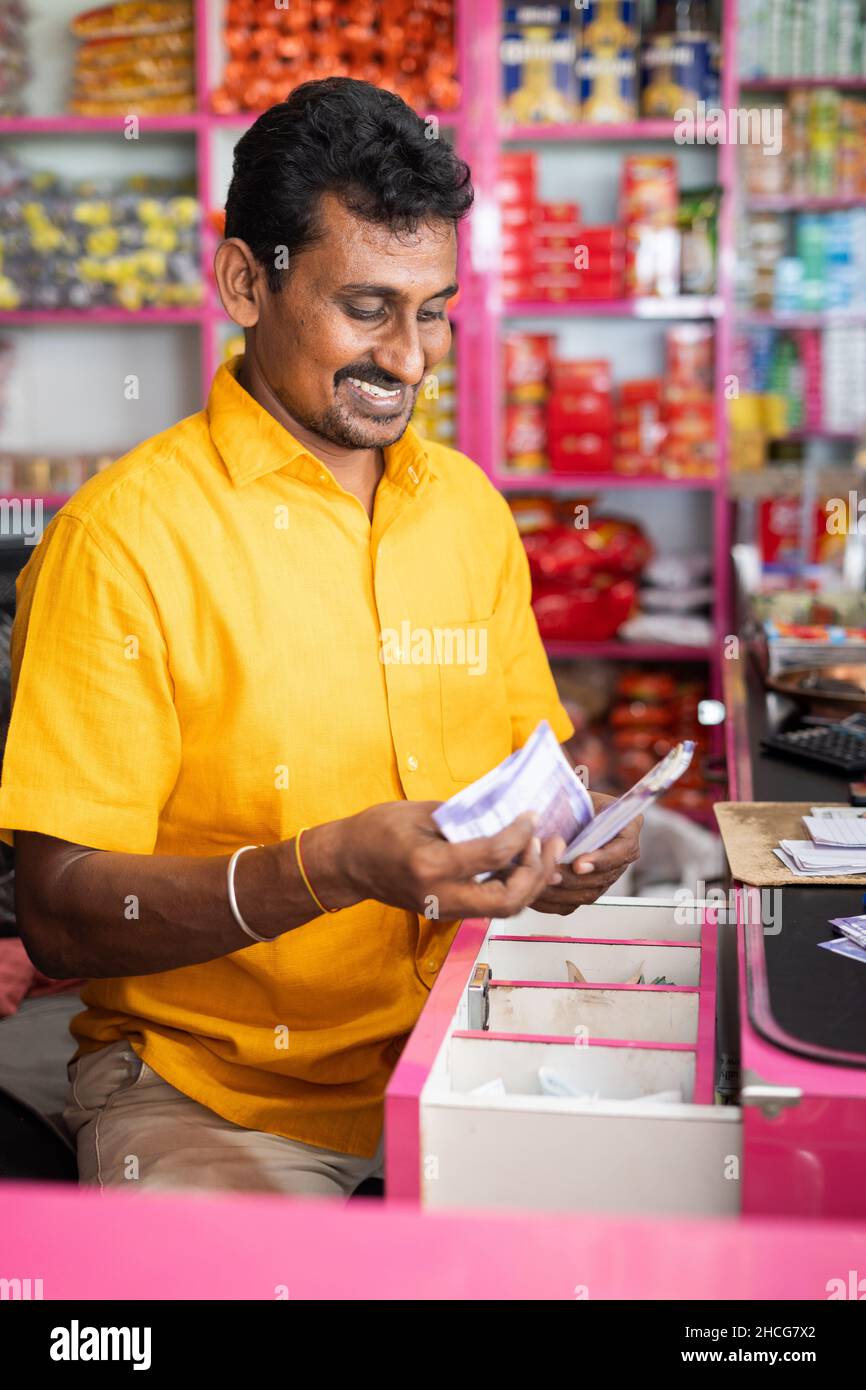 Side view of Happy smiling Groceries or Kirana Merchant small business