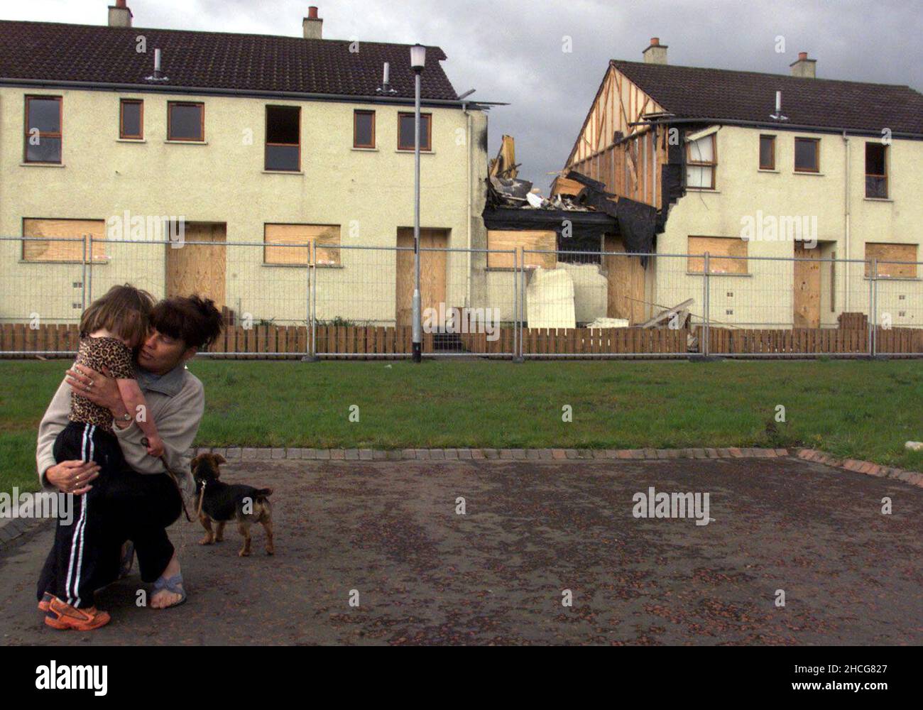 File photo dated 22/04/99 of a mother comforting a young child as contractors moved in to demolish the Quinn family home in Ballymoney, scene of the arson attack in July 1998 which killed 3 young Catholic boys Richard, Mark and Jason at the height of the Drumcree stand off. Prime Minister Tony Blair told the head of the Orange Order to call for an immediate end to the Drumcree parading dispute hours after three young brothers were killed in a loyalist firebomb attack, according to newly released documents from the National Archives. Issue date: Wednesday December 29, 2021. Stock Photo