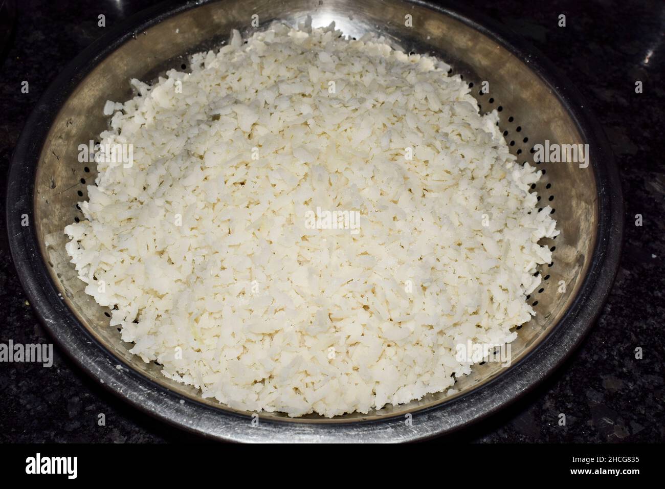 Heaps of Soaked flattened rice for cooking maharastrian dish of Poha. White beaten rice is