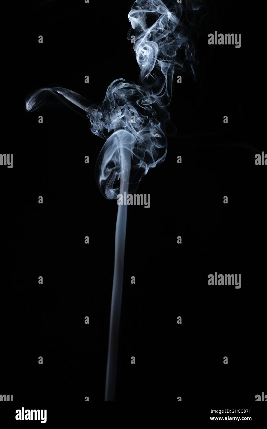 Smokeping Using Curl Clouds of curls of smoke on a black background Stock Photo - Alamy