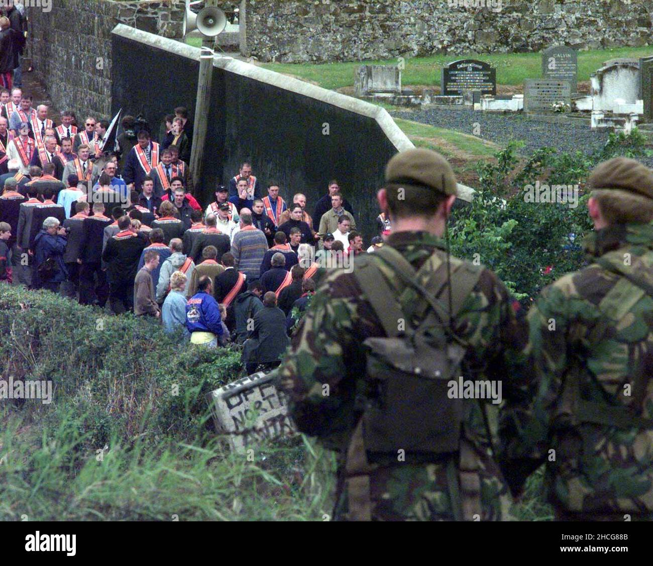 File photo dated 13/07/98 of soldiers watching as the Portadown District No 1 Orangemen marched past Drumcree Church and back from the barricaded road. Prime Minister Tony Blair told the head of the Orange Order to call for an immediate end to the Drumcree parading dispute hours after three young brothers were killed in a loyalist firebomb attack, according to newly released documents from the National Archives. Issue date: Wednesday December 29, 2021. Stock Photo