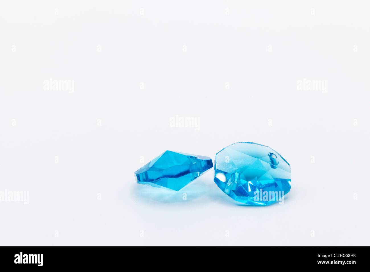 two beautiful blue crystals in plastic on a white background Stock Photo