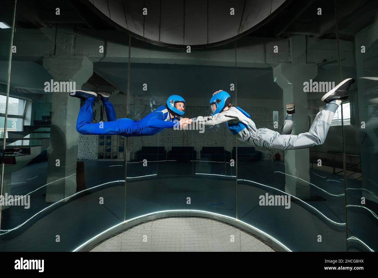 A man and a woman enjoy flying together in a wind tunnel. Free fall ...