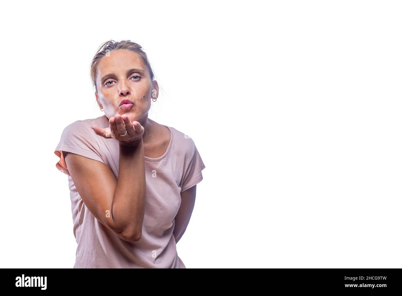 An adult woman sending air kiss on a white background Stock Photo