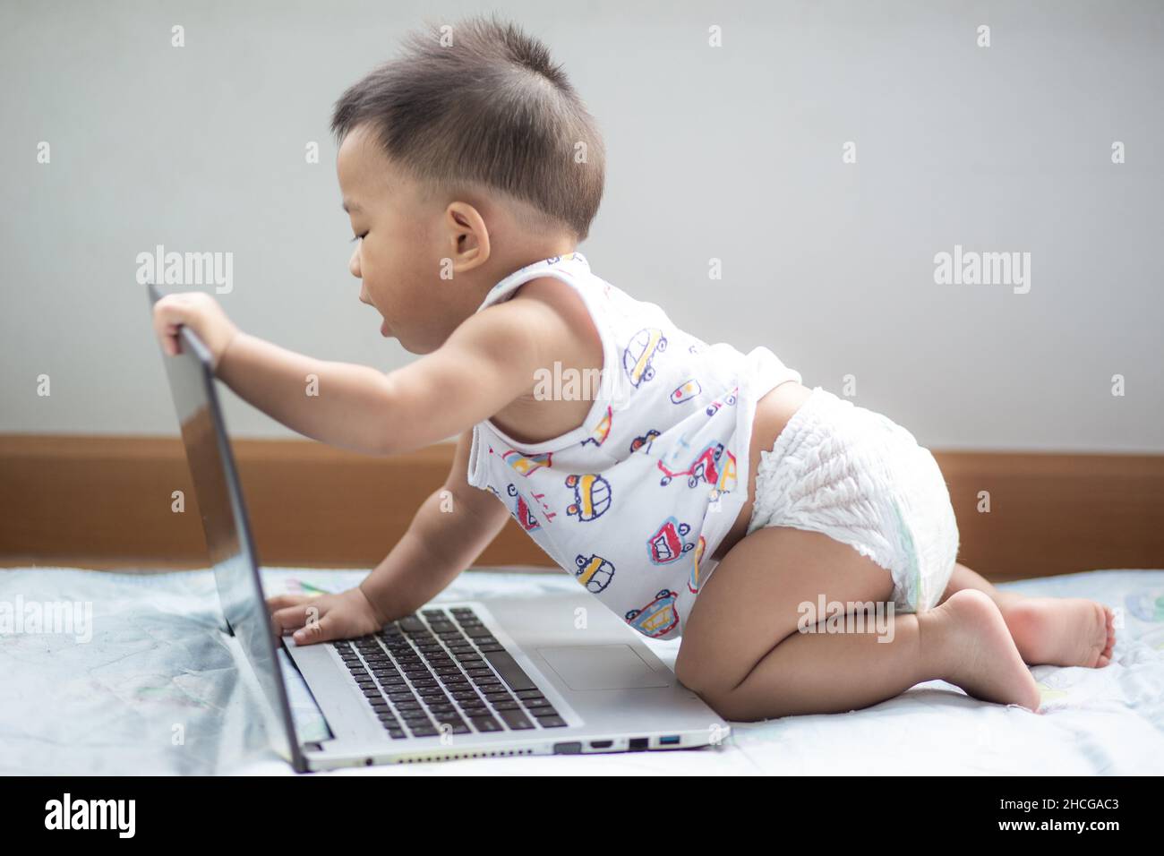 Cute asian baby boy playing laptop computer funny boy with computer ...