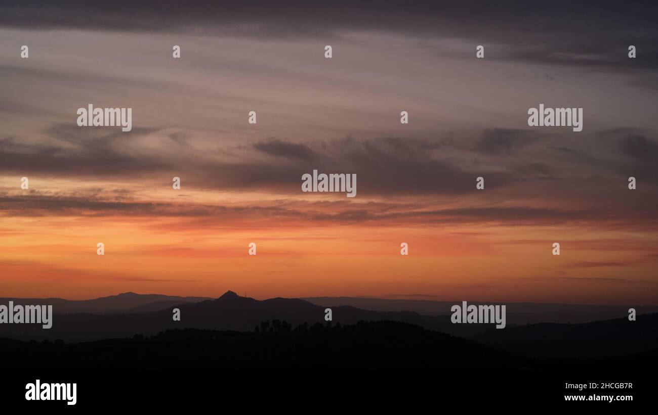 Soft pastel colours in post sunset sky over valleys and rolling hills of Valenciana region Spain Stock Photo