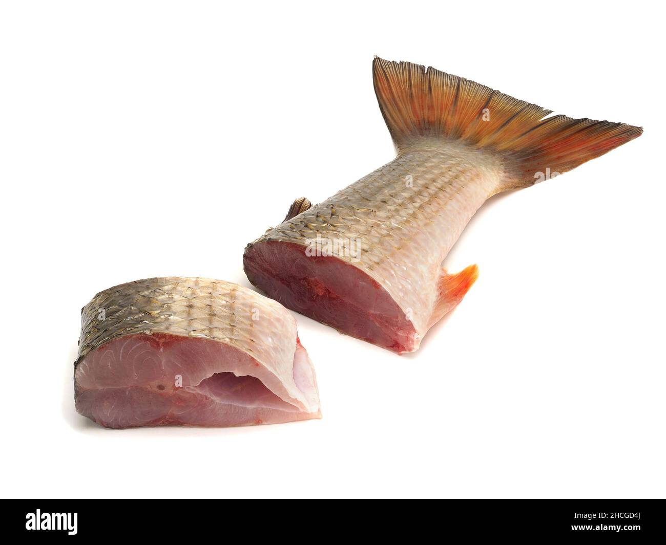 Two pieces of red-finned mullet isolated on a white background Stock Photo