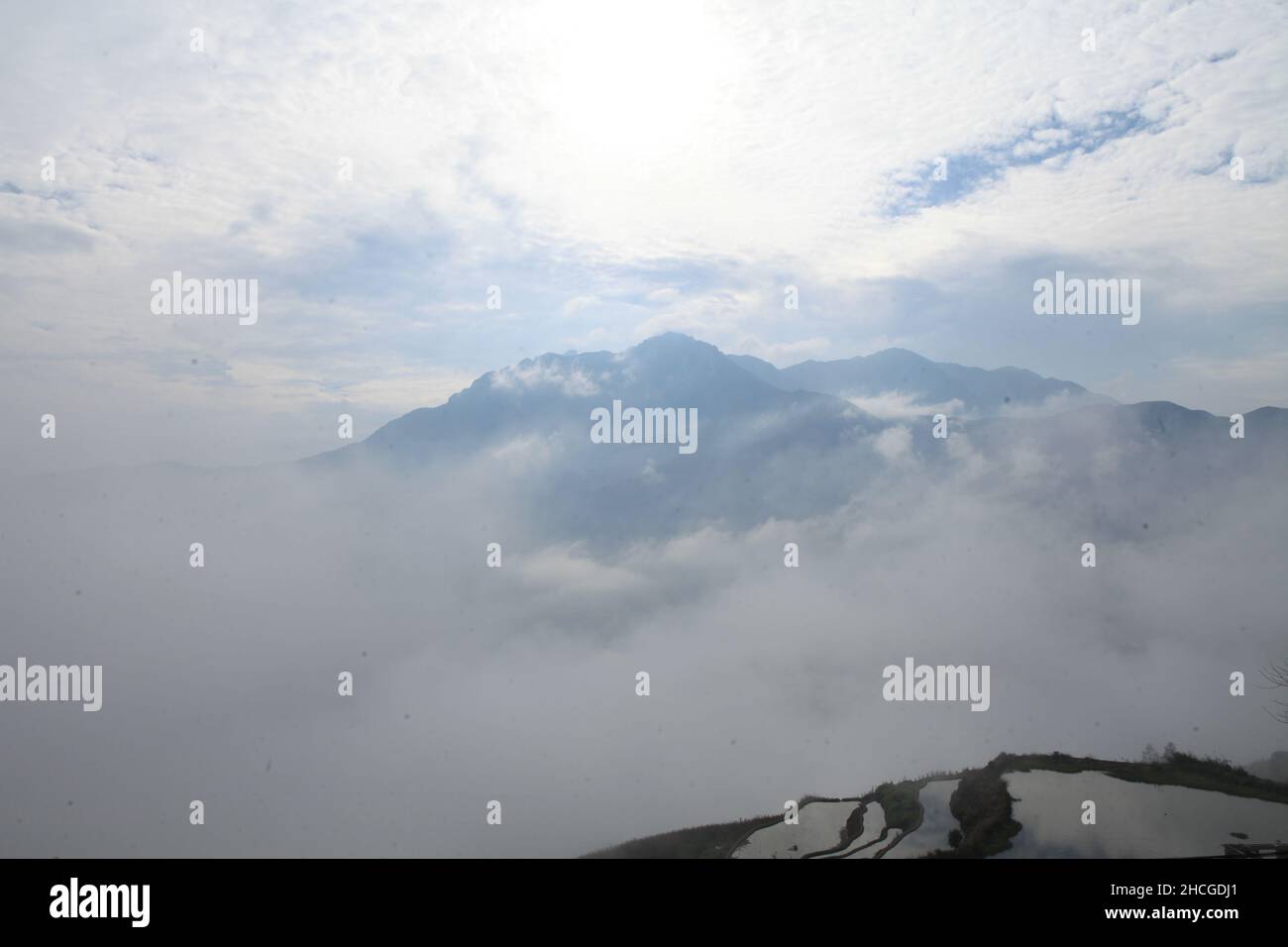 Beautiful view of rocky mountains enveloped in white clouds Stock Photo