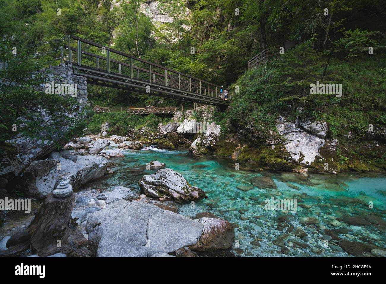 Breathtaking scene of clear streaming water under a bridge connecting two banks Stock Photo