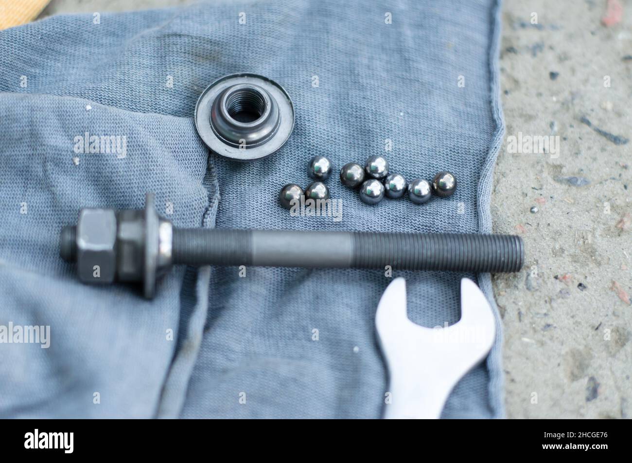 Bearing balls and safety nut in focus. The hub axle and wrench are out