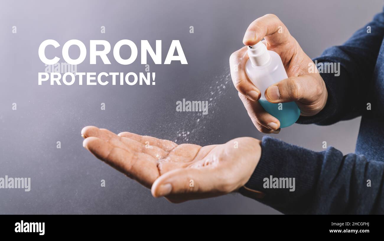 Coronavirus. man cleaning hands at the office. with alcohol spray for corona virus. spraying alcohol gel or antibacterial spray sanitizer to portect c Stock Photo