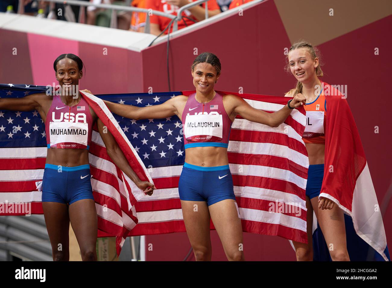 Dalilah Muhammad ,Sydney McLaughlin and Femke Bol with the US flag in