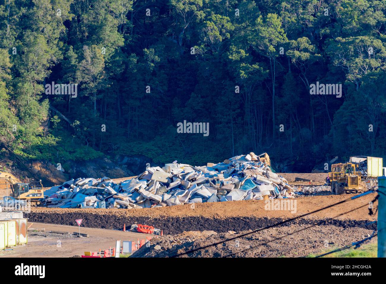 A large pile of used mattresses waiting to be shredded. All metal is extracted and recycled and the remaining inner foam and covers go into landfill Stock Photo