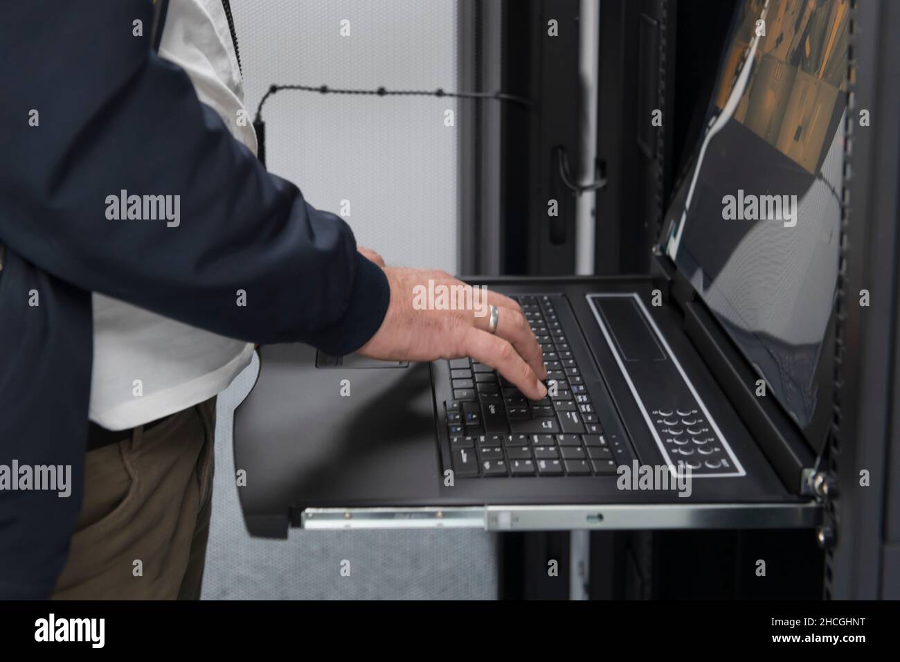 Close up on Data Center Engineer hands Using keyboard on a ...
