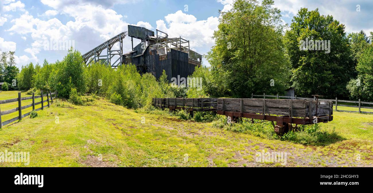A historic coal breaker with a dilapidated wooden rail car in the foreground. Stock Photo