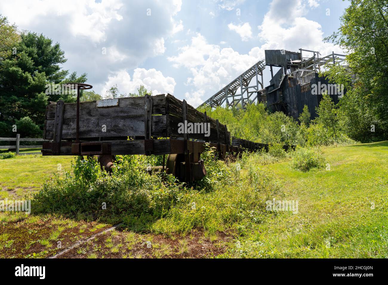 A historic coal breaker with a dilapidated rail car in the foreground