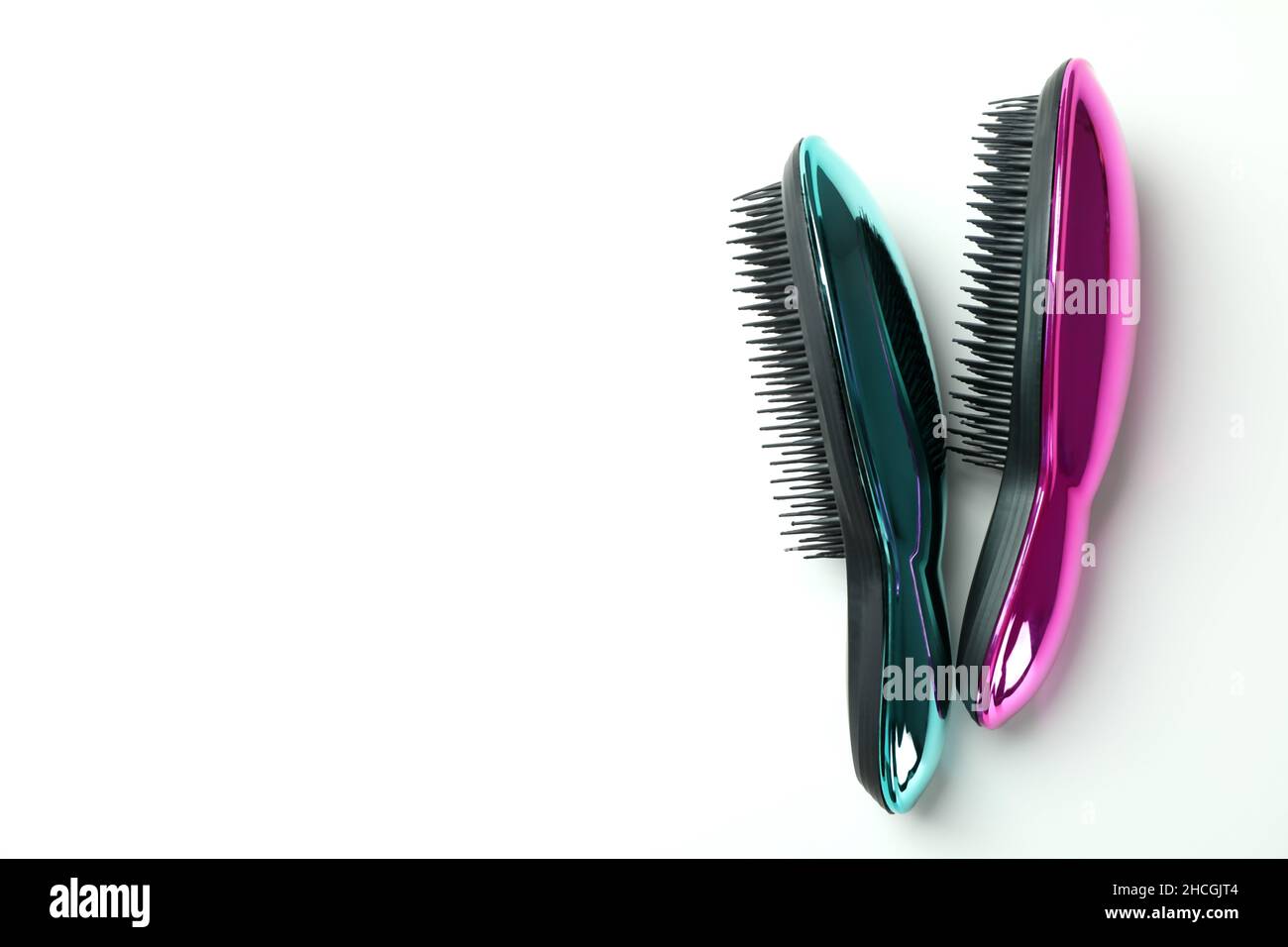 Colored plastic hair brushes on white background Stock Photo