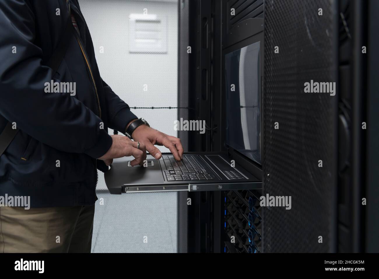 Close up on Data Center Engineer hands Using keyboard on a ...
