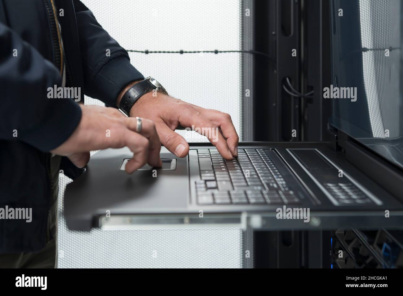 Close up on Data Center Engineer hands Using keyboard on a ...
