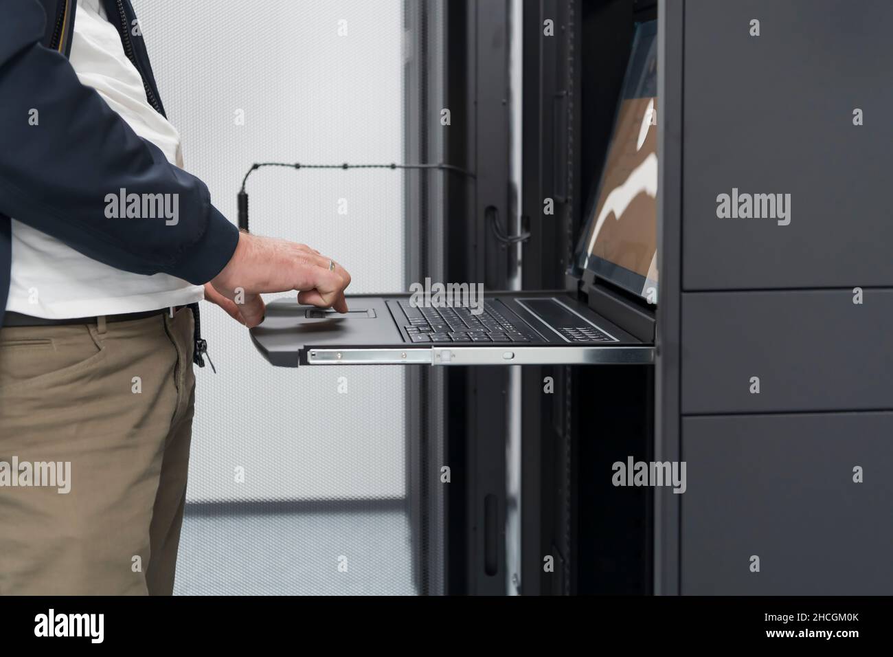 Close up on Data Center Engineer hands Using keyboard on a ...