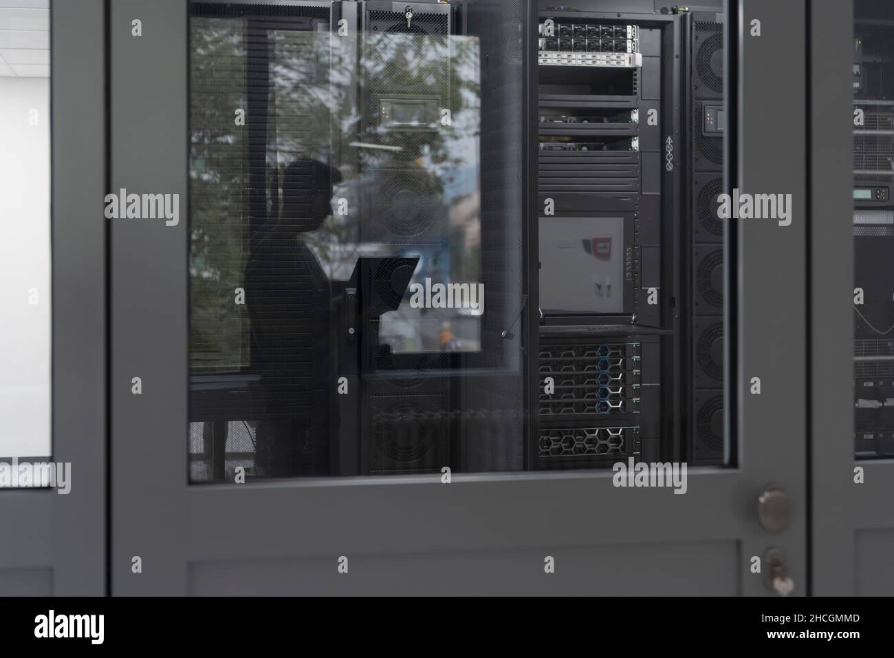 Software Engineer Working on a Laptop Computer in a Modern Server room