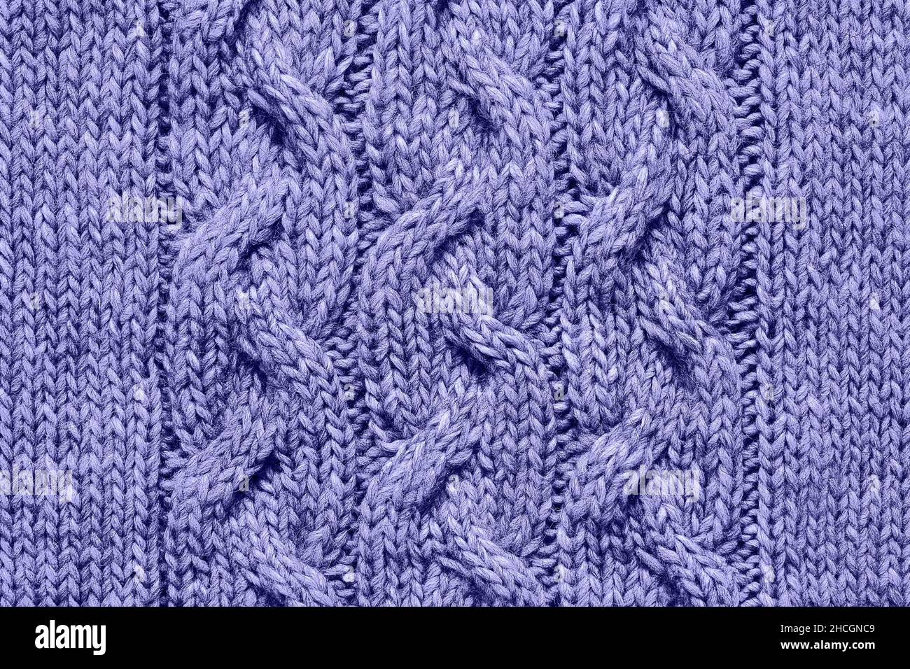 Lilac very peri knitted texture, handmade knitwear. Color of the year 2022 toned. Background. Stock Photo