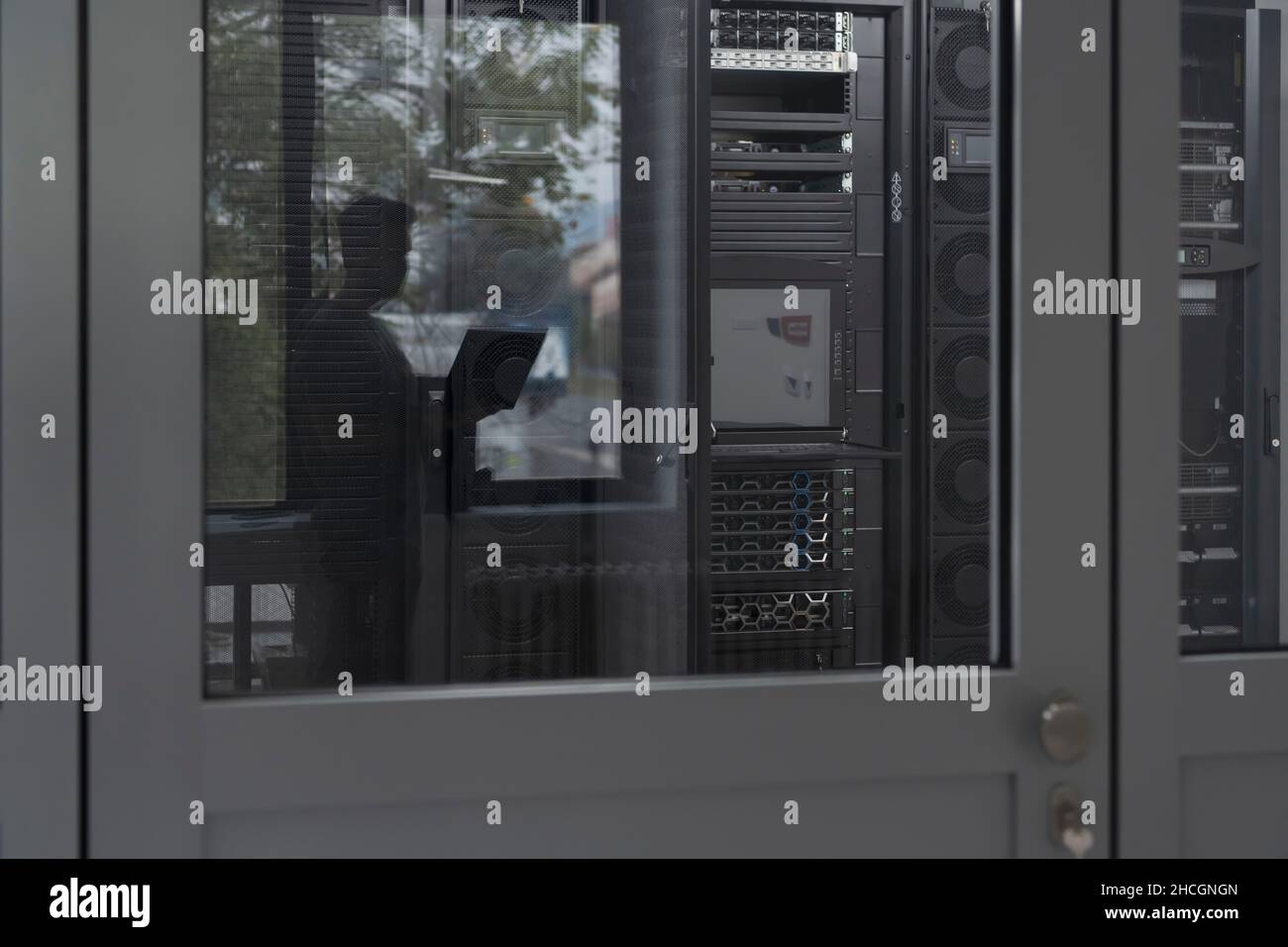 Software Engineer Working on a Laptop Computer in a Modern Server room