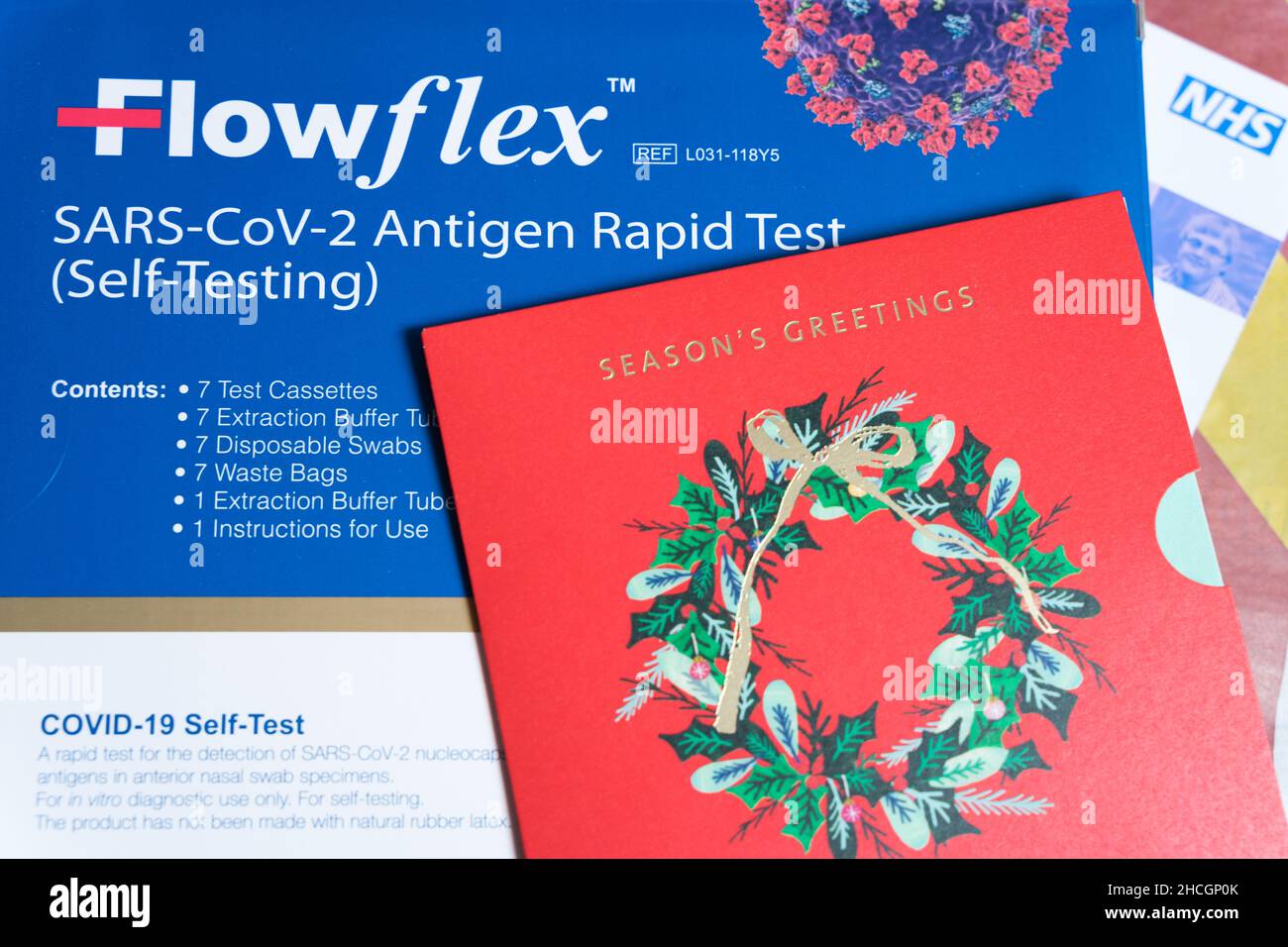 Red Christmas greeting card place on top of a patch of Flowflex rapid test kit box Stock Photo