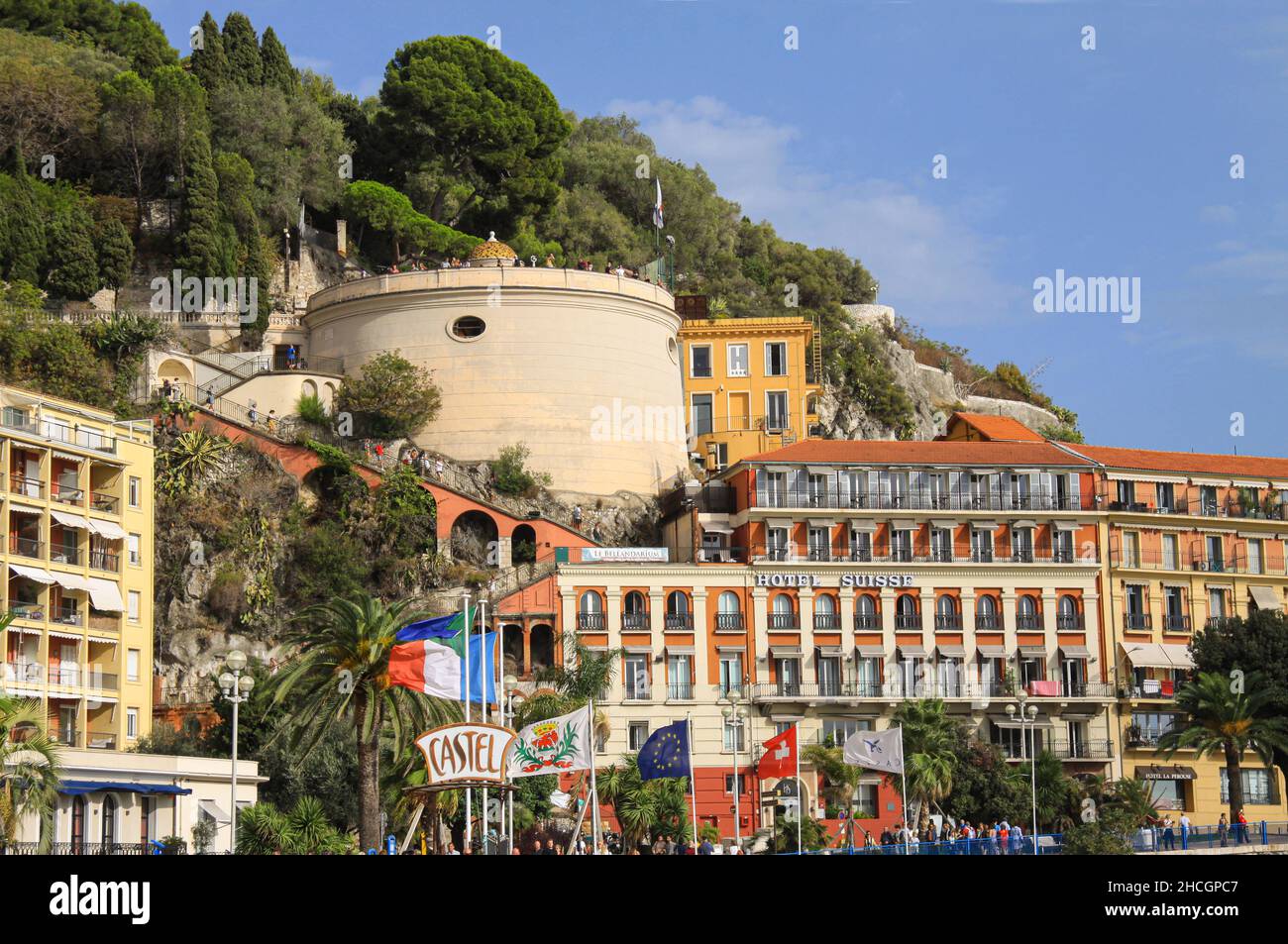 Castel beach and hill on a sunny summer day with people walking on the Promenade des Anglais with the great tower and blue sky. Nice, France - Septemb Stock Photo