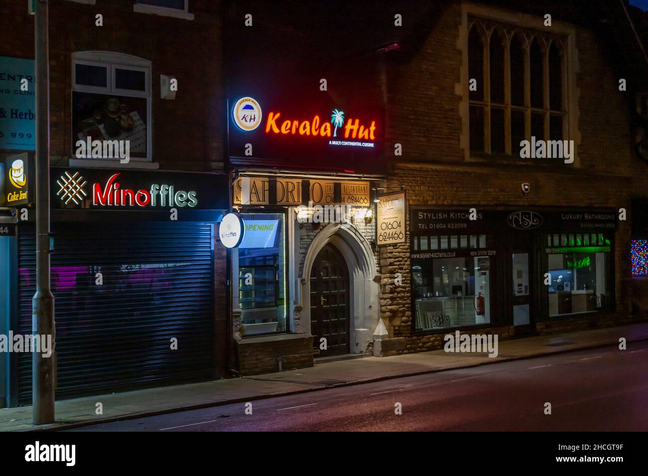 Neon signs on shop fronts on Wellingborough road, Northampton, England