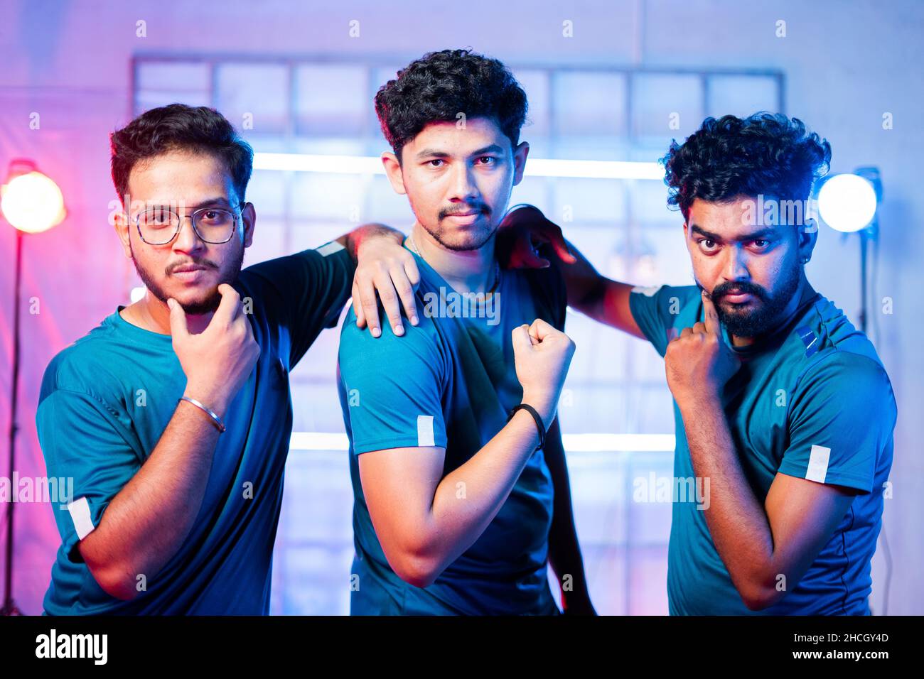 Team of professional gamer on stage or arena in attitude by showing different hand gestures while looking at camera during championship tournment on Stock Photo
