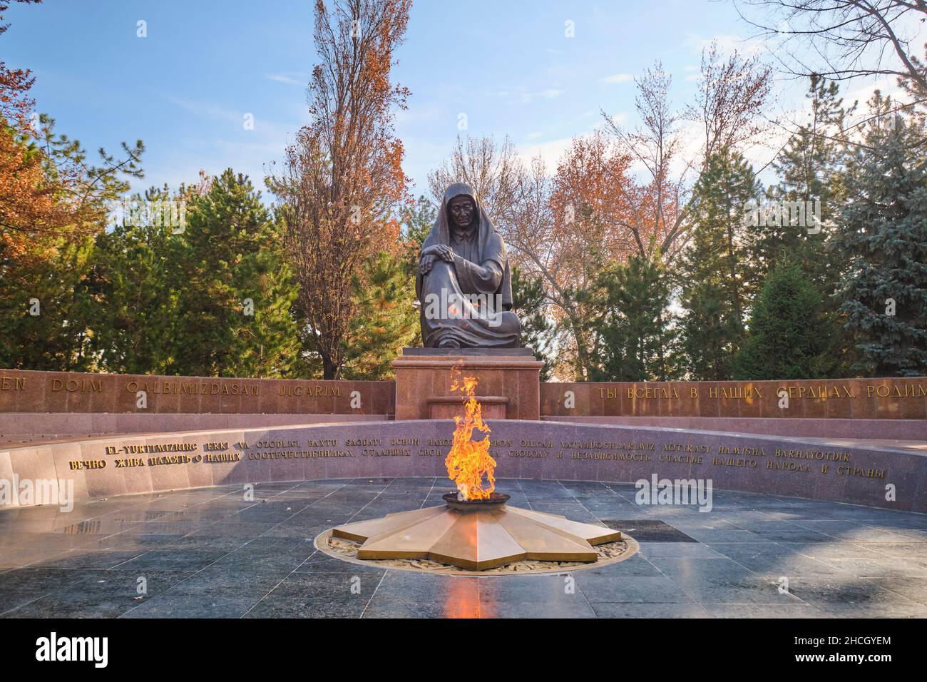 The eternal fire flam and wailing mother statue. At Memorial Square in Tashkent, Uzbekistan. Stock Photo