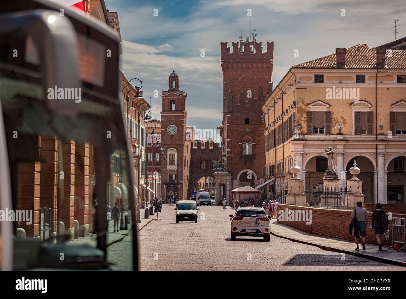 FERRARA, ITALY 29 JULY 2020 : Evocative view of the road leading to the historic center of Ferrara with a view of the castle and life on the road Stock Photo