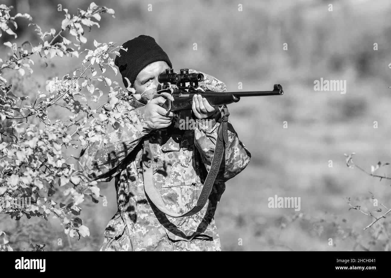 Hunting skills and weapon equipment. How turn hunting into hobby. Bearded man hunter. Army forces. Camouflage. Military uniform fashion. Man hunter Stock Photo