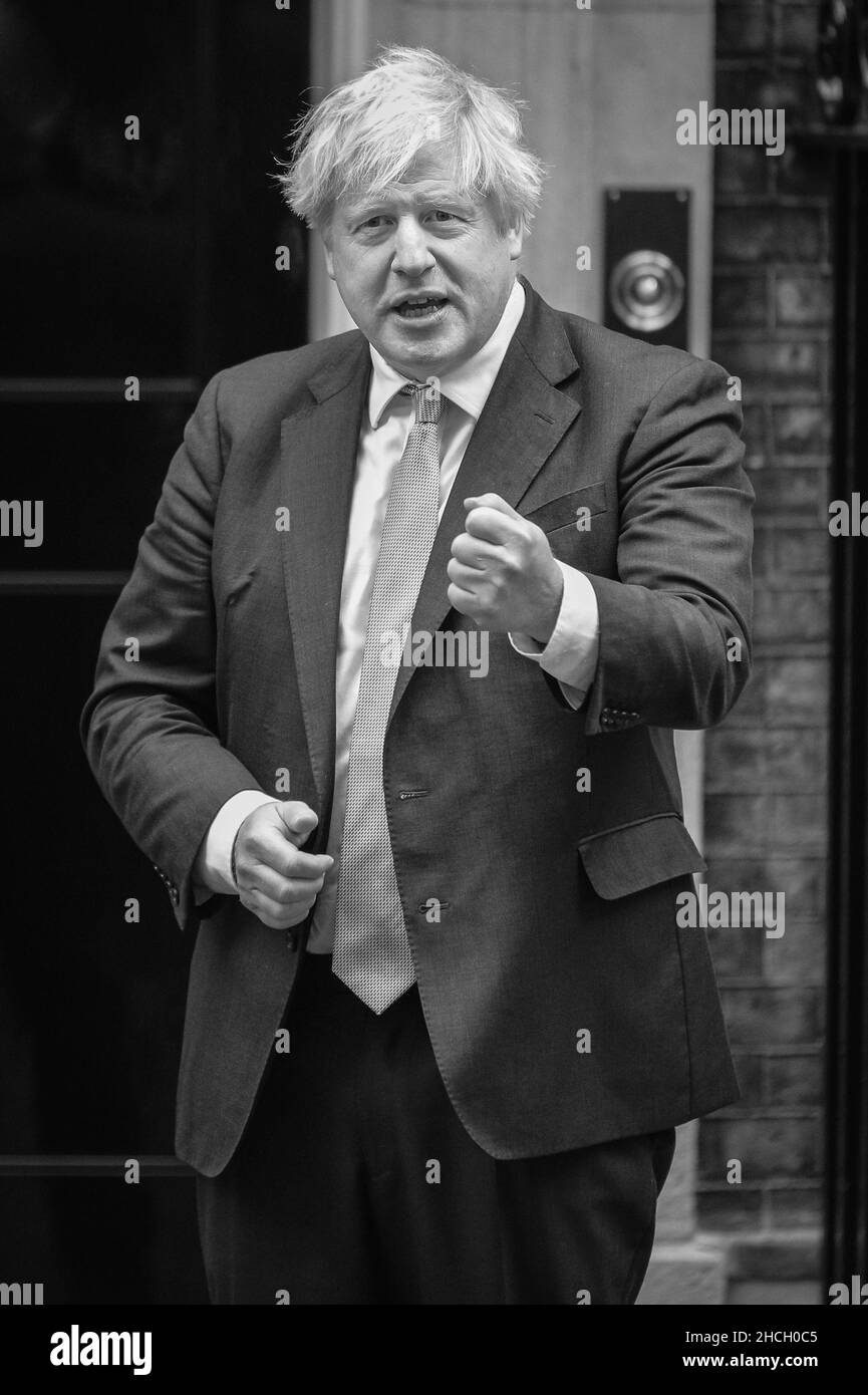 British Prime Minister Boris Johnson speaks and gestures outside 10