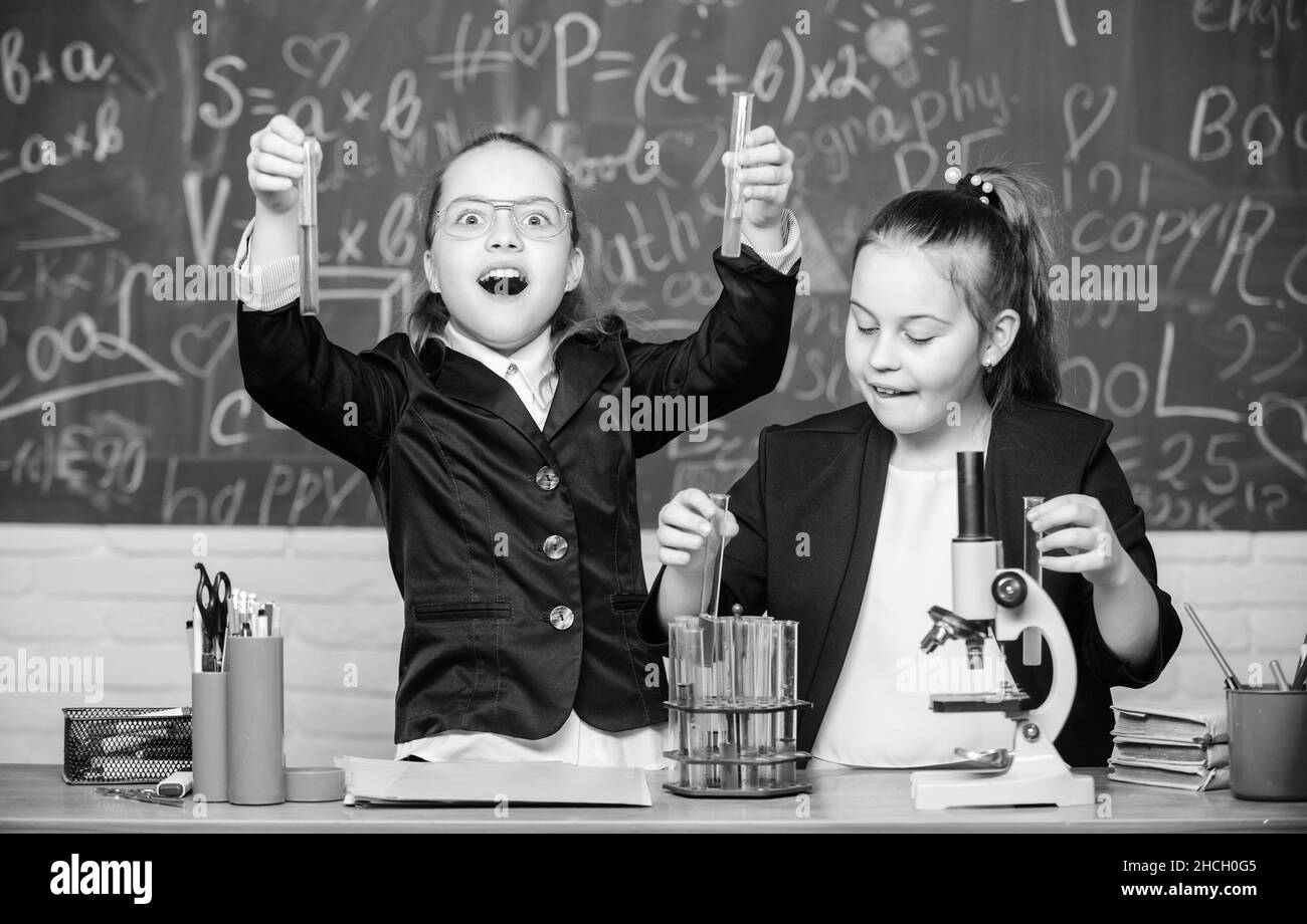 Girls school uniform busy with proving their hypothesis. School experiment. Science concept. Gymnasium students with in depth study of natural Stock Photo