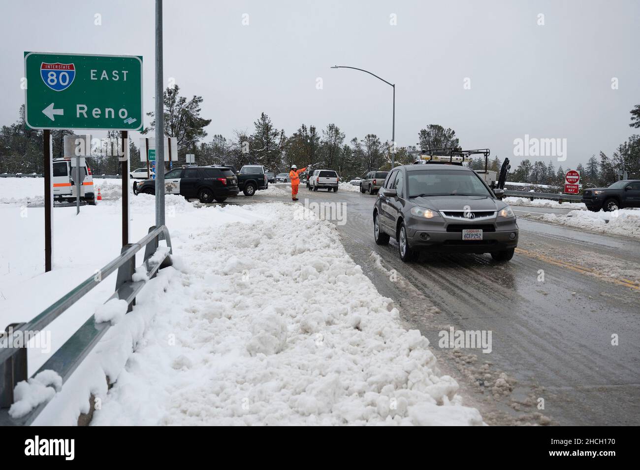 USA. 27th Dec, 2021. A Caltrans worker directs traffic on Monday, Dec. 27, 2021, at the Applegate exit where Interstate 80 east bound was closed due to snow levels. (Photo by Hector Amezcua/The Sacramento Bee/TNS/Sipa USA) Credit: Sipa USA/Alamy Live News Stock Photo