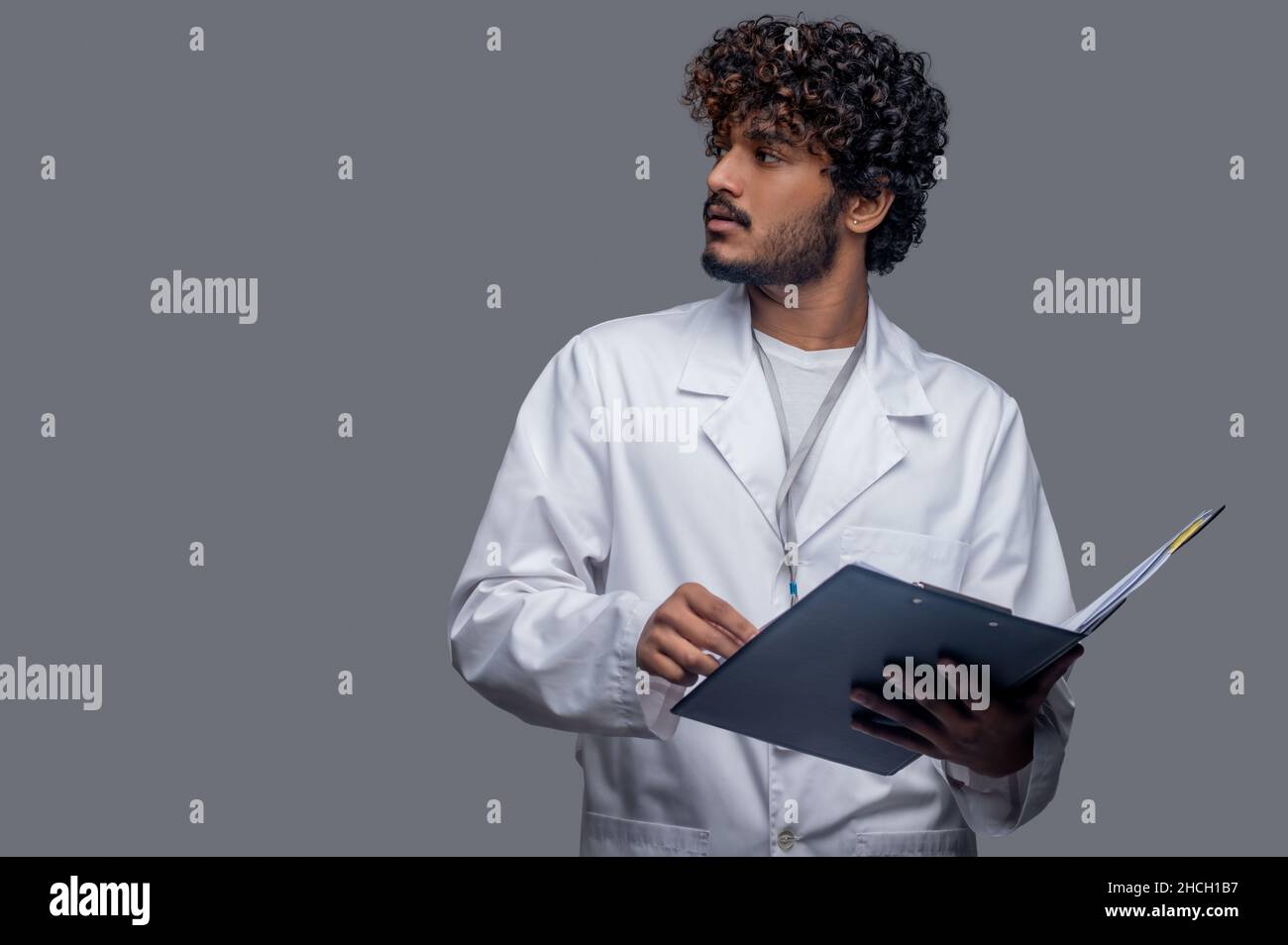 Handsome doctor holding folder hi-res stock photography and images - Alamy