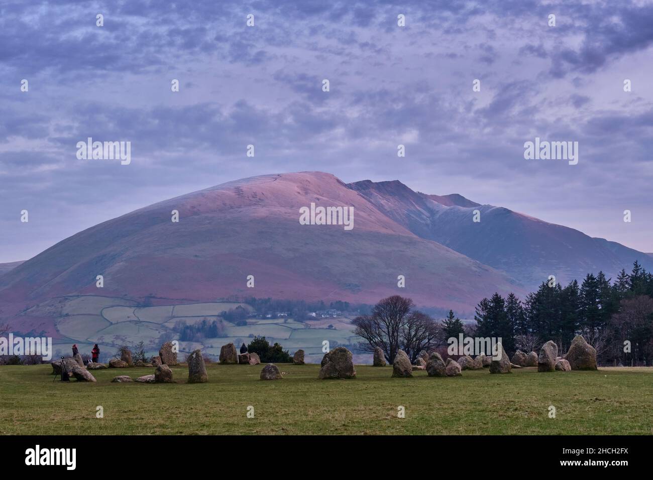 Dusting of snow on Blease Fell and the ridge path to Blencathra, seen from Castlerigg Stone Circle near Keswick, Lake District, Cumbria. Stock Photo