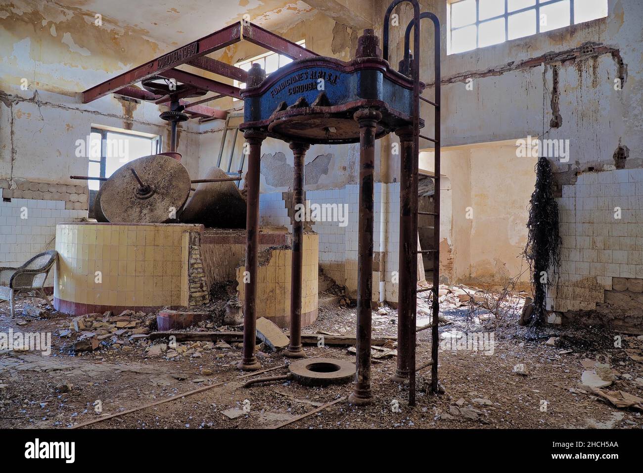 Inside an olive mill with press, grinding cone and washbasin Stock Photo